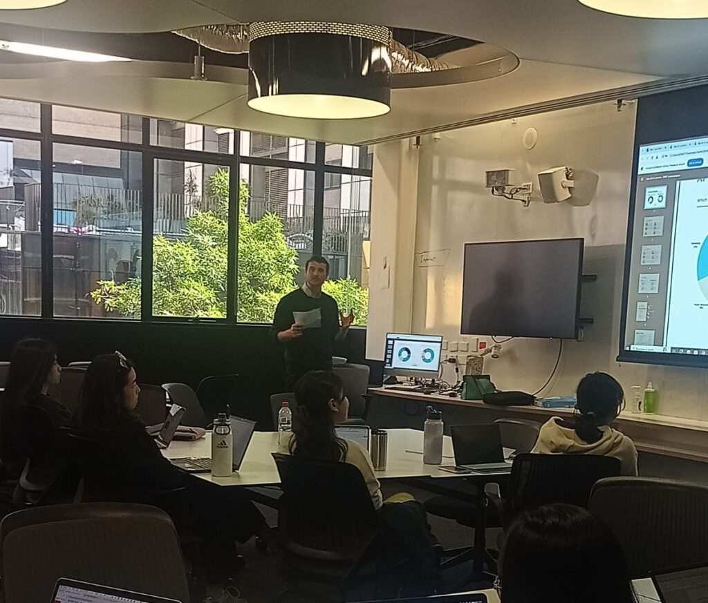 new vers Andrew Tomison delivering AI search strategy training session, bridging behavioural science and digital communication.