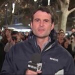 Andrew Tomison (formerly known as Thompson) reporting from the field in Melbourne for ABC News TV.